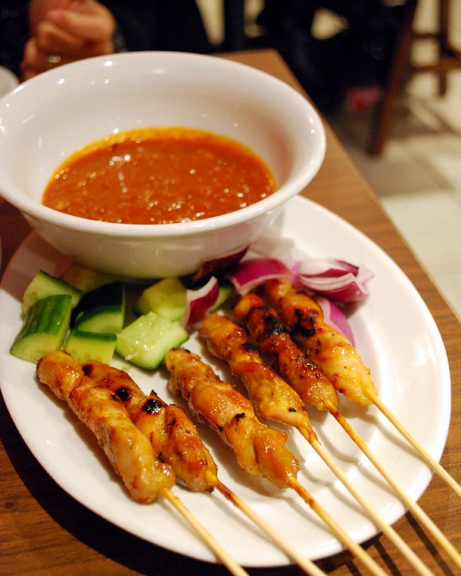 Chicken satay grilling over charcoal at a Kuching night market